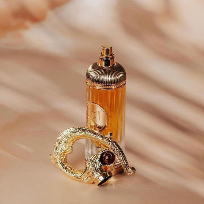 Refect Beauty Lattafa Pride Sehr Eau de Parfum in a ribbed glass bottle with a gold dragon-shaped cap on a warm surface