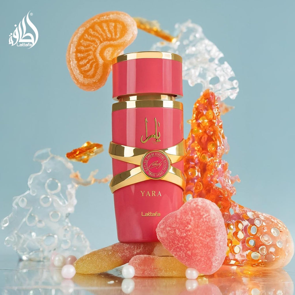Refect Beauty Lattafa Yara Candy Eau de Parfum in a pink bottle surrounded by candy, fruit slices, and sugar crystals.
