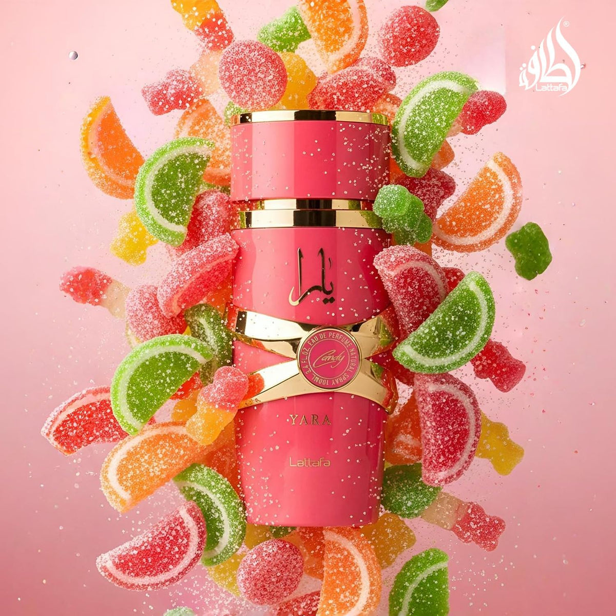 Refect Beauty Lattafa Yara Candy Eau de Parfum bottle surrounded by colorful gummy candies on a pink background.