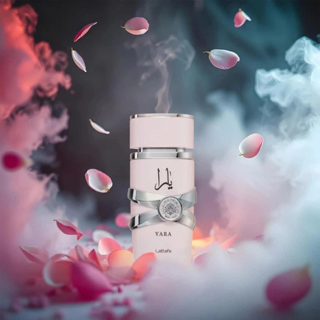 Refect Beauty Lattafa Yara Eau de Parfum bottle surrounded by floating flower petals and soft pink and blue smoke