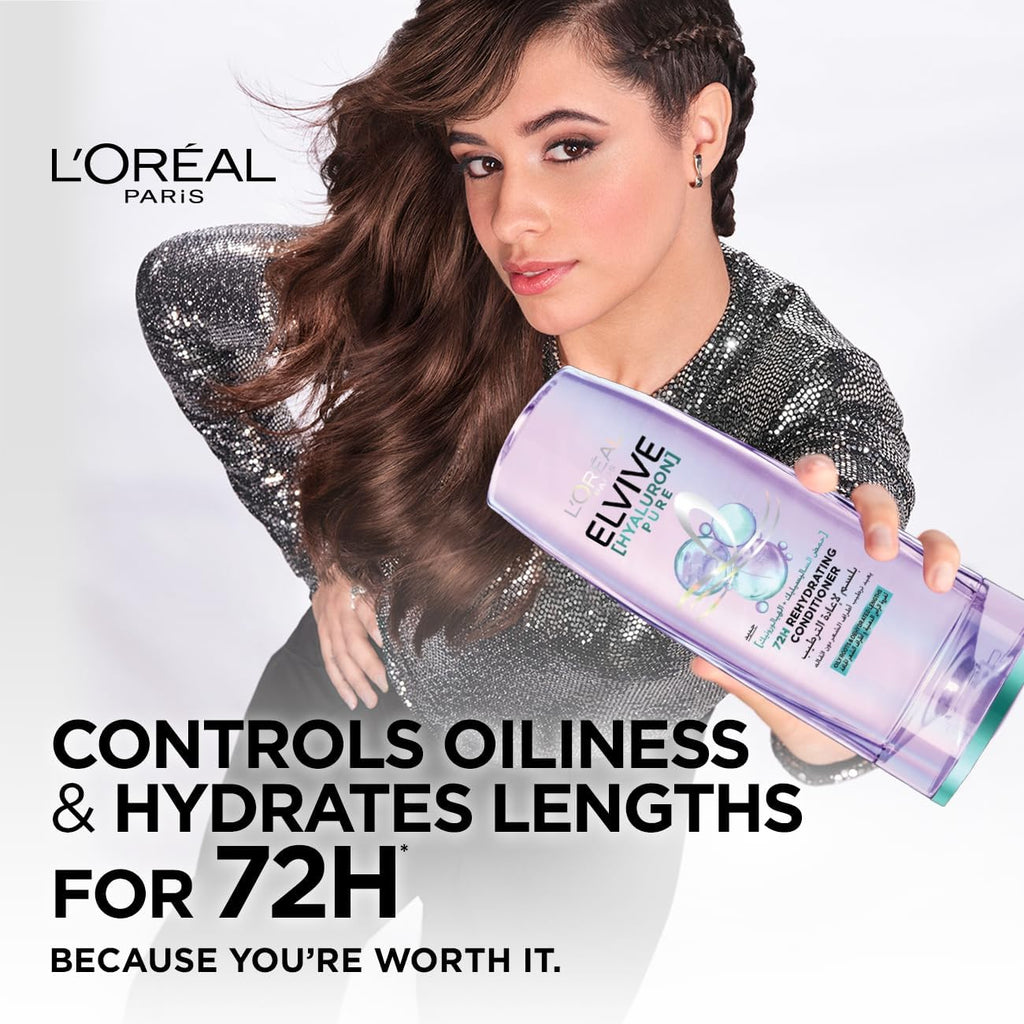 Refect Beauty L'Oreal Paris Elvive Hyaluron Pure conditioner bottle held by a woman with long wavy brown hair