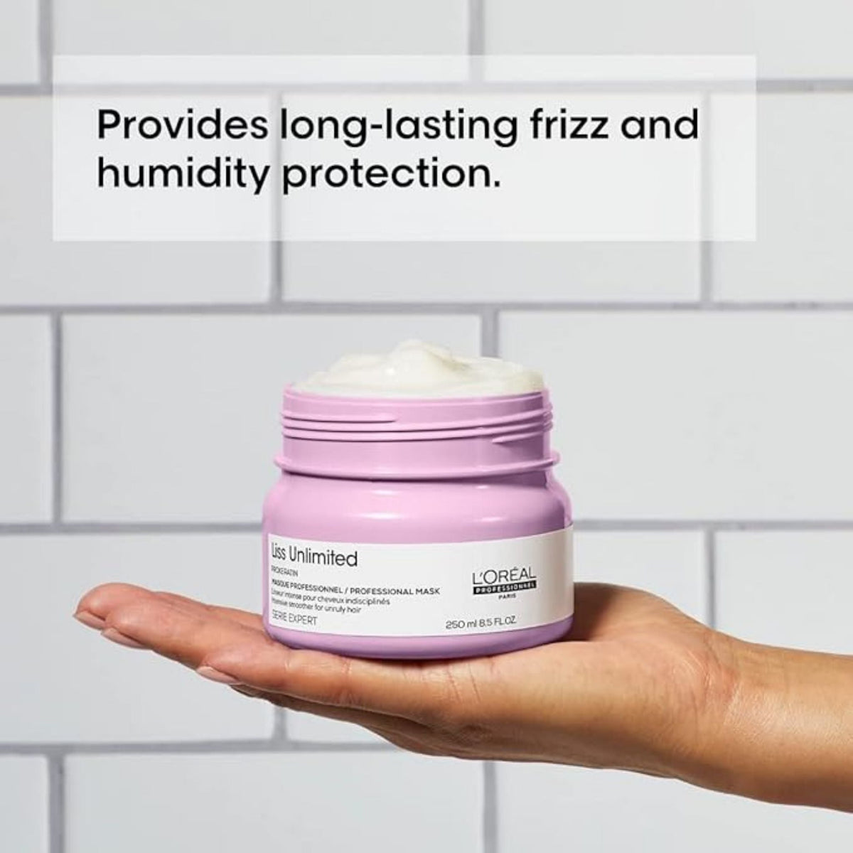 Refect Beauty L'Oréal Professionnel Liss Unlimited hair mask in a light purple jar held in a palm against white tiles.