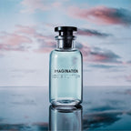 Refect Beauty Louis Vuitton Imagination Eau de Parfum bottle with light blue liquid against a sunset sky background.