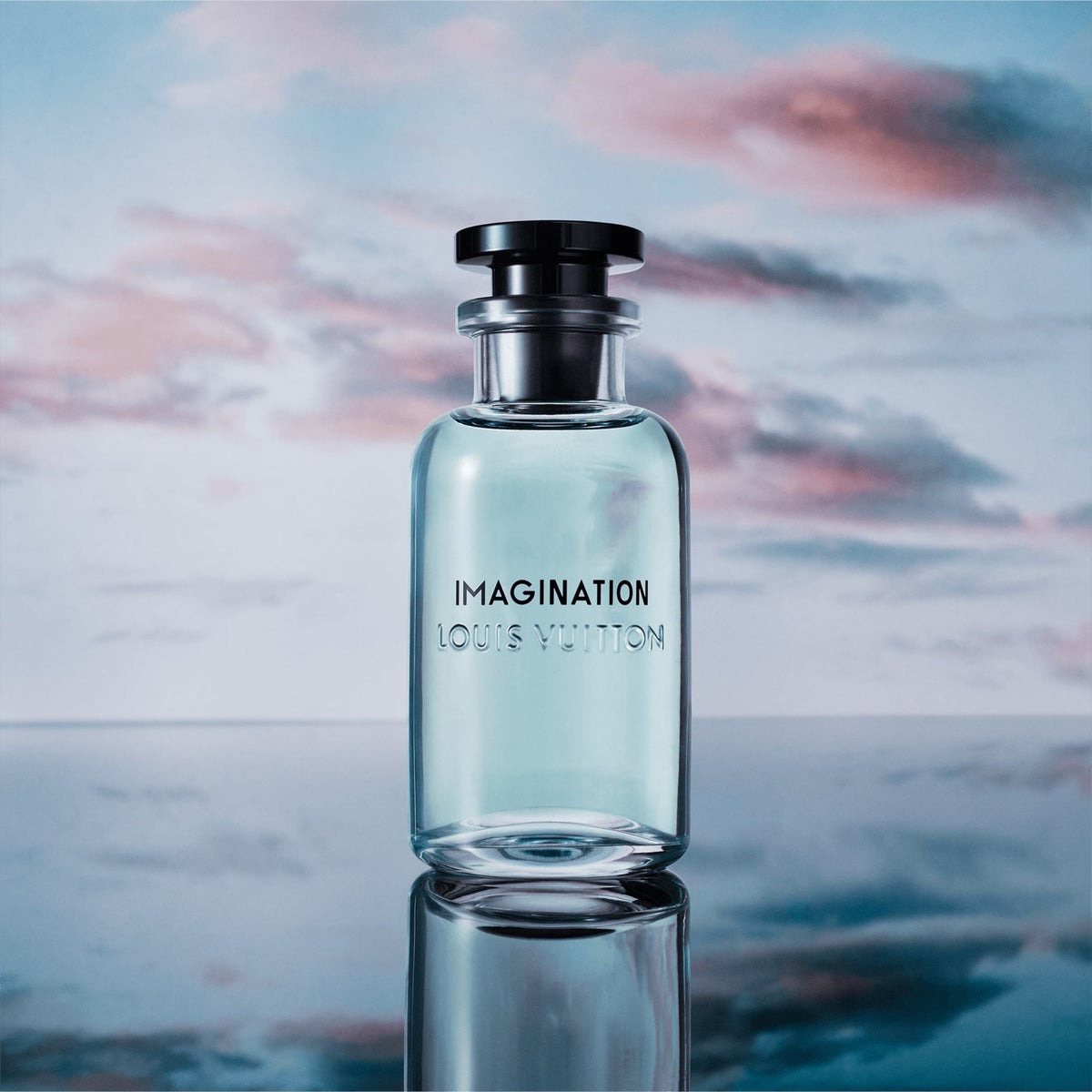 Refect Beauty Louis Vuitton Imagination Eau de Parfum bottle with light blue liquid against a sunset sky background.