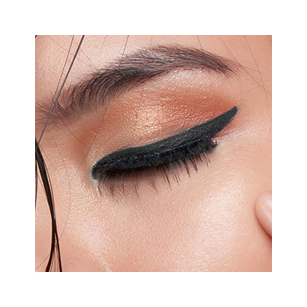 Refect Beauty LUNA Eye Liner Pencil applied as a sharp black winged line on a model with warm copper eyeshadow
