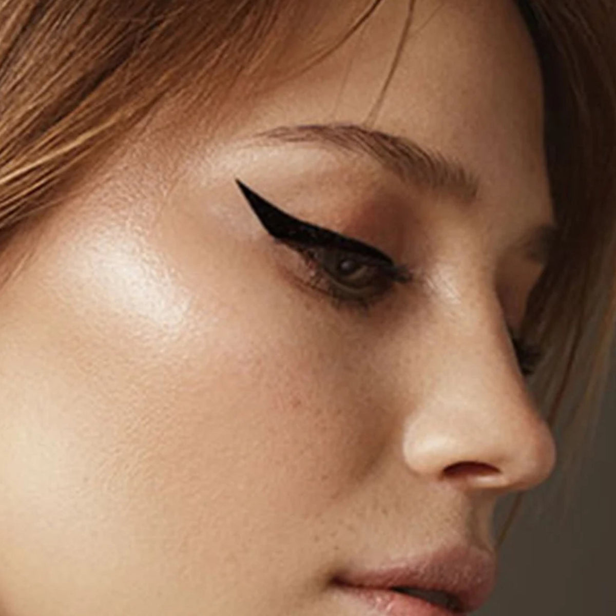 Refect Beauty LUNA Dip Liner applied as a sharp black winged eyeliner on a model's eyelid for a defined look.