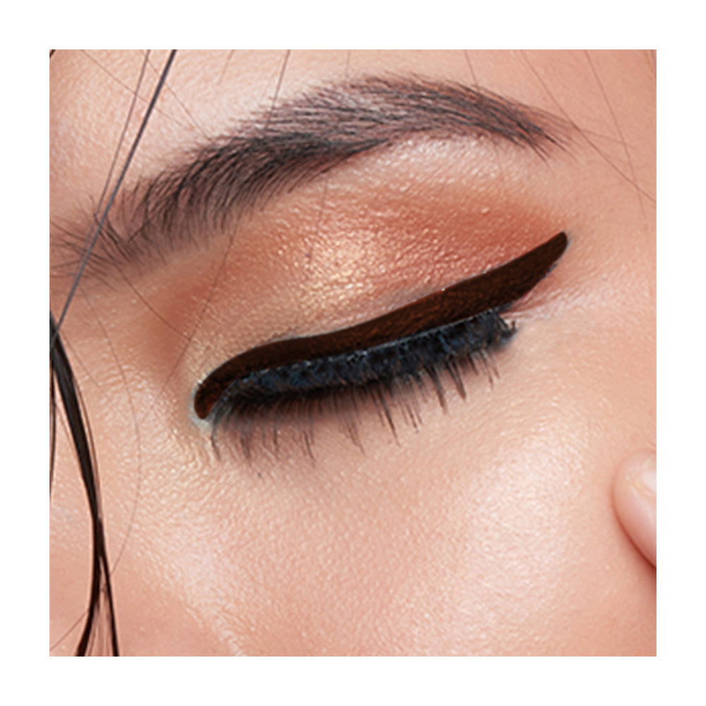 Refect Beauty LUNA Eye Liner Pencil applied as a precise dark brown winged line on a model with shimmering gold eyeshadow