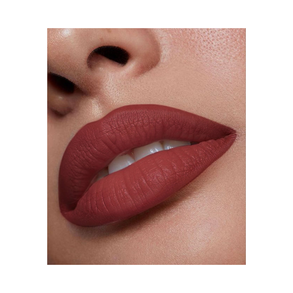 Refect Beauty LUNA semi matte lipstick in a deep brick red shade applied on lips for a smooth, vibrant finish.