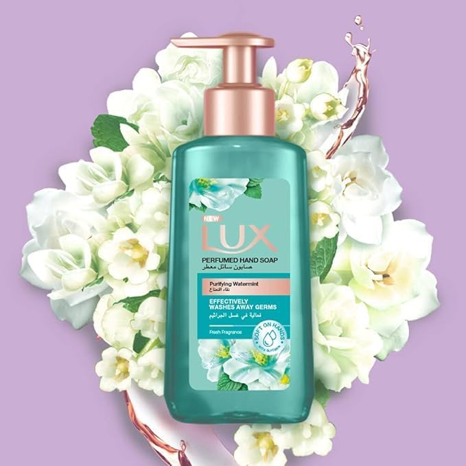 Refect Beauty Lux Purifying Watermint liquid hand wash in a teal bottle with a rose gold pump, surrounded by flowers.