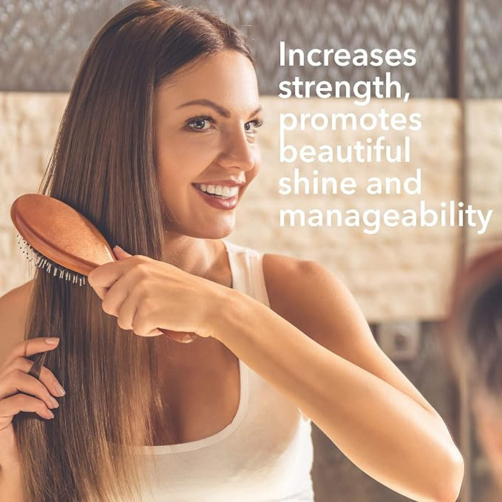 Refect Beauty model brushing long, smooth, shiny hair after using Macadamia Natural Oil Healing Oil Spray