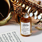 Refect Beauty Maison Margiela Replica Jazz Club perfume bottle next to a golden saxophone and sheet music.
