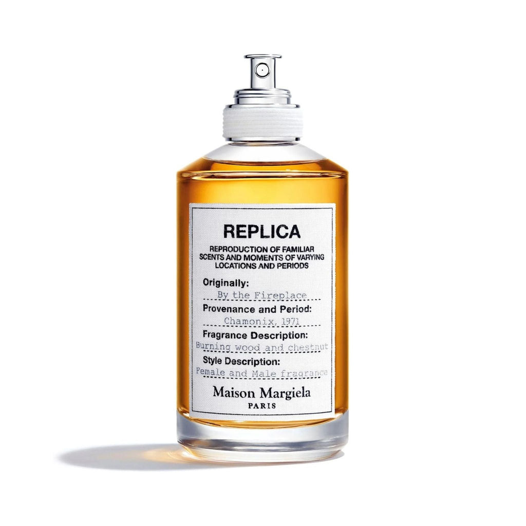Refect Beauty Maison Margiela Replica By the Fireplace eau de toilette in a clear glass bottle with amber liquid.