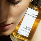 Refect Beauty Mancera Coco Vanille Eau de Parfum bottle held near a woman's face in warm sunlight