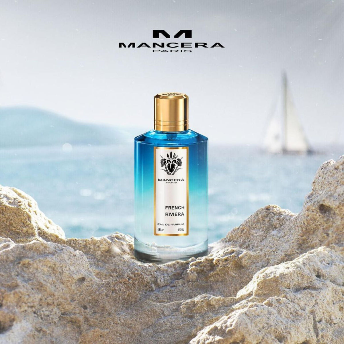 Refect Beauty Mancera French Riviera Eau de Parfum bottle with blue gradient glass on a rocky beach by the sea