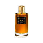 Refect Beauty Mancera Tonka Cola Eau de Parfum in a cylindrical glass bottle with a gold cap and amber liquid.
