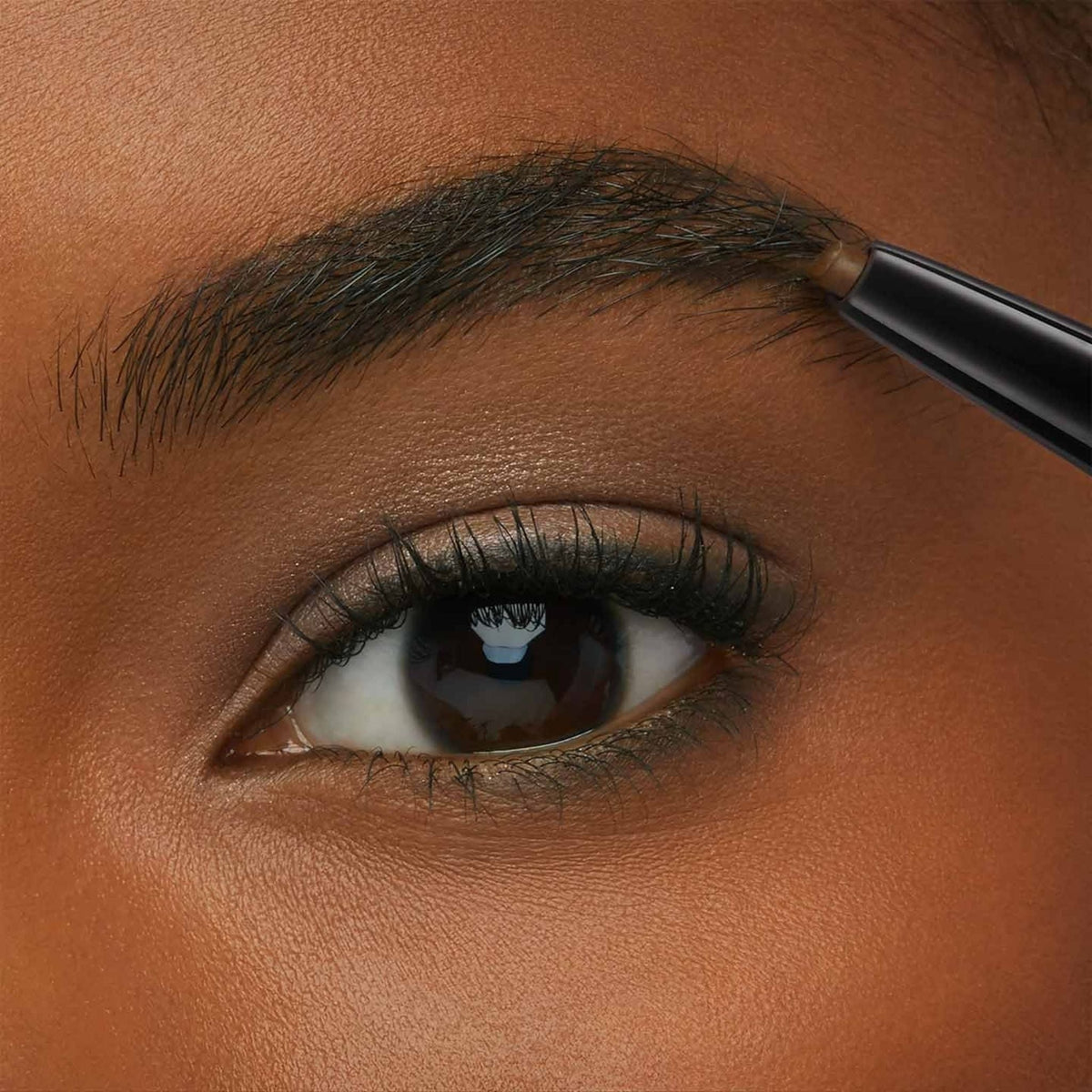 Refect Beauty Maybelline Express Brow Duo pencil defining and shaping a natural eyebrow on a person with dark skin