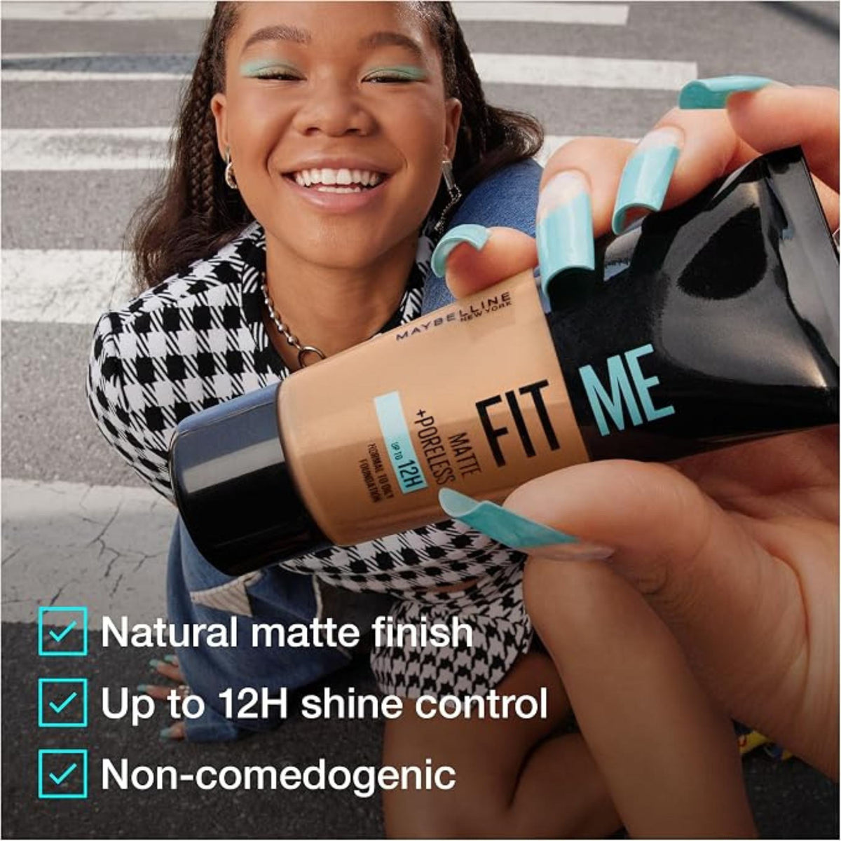 Refect Beauty Maybelline Fit Me Matte Poreless Foundation held by a smiling woman with matching blue nails
