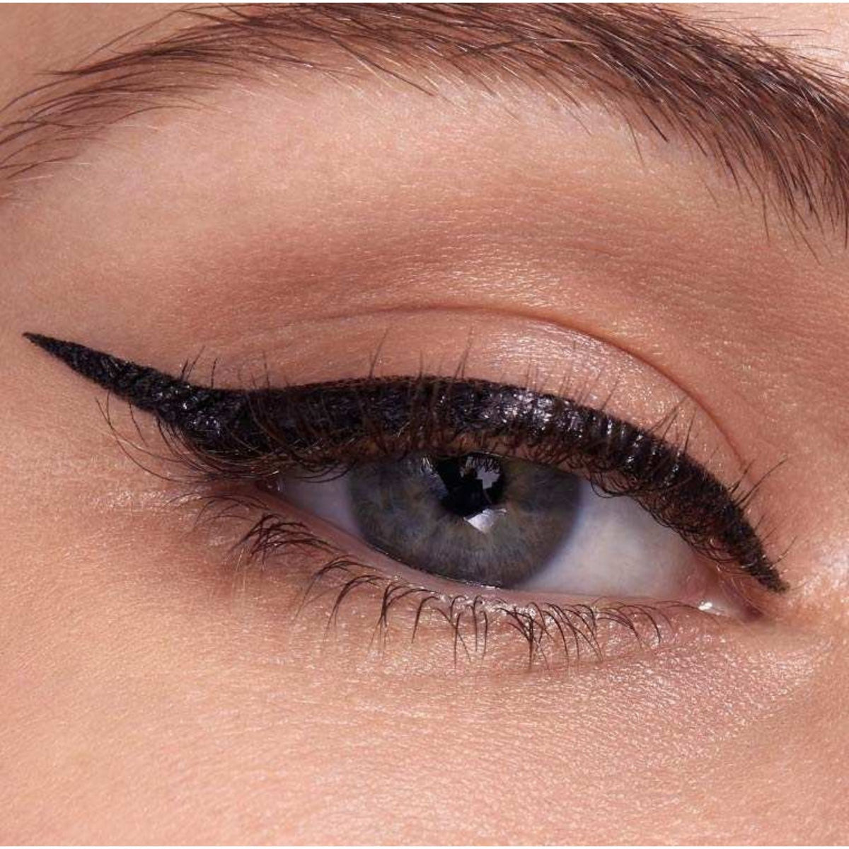 Refect Beauty Maybelline Hyper Easy liquid eyeliner applied as a sharp black winged cat eye on a blue-eyed model
