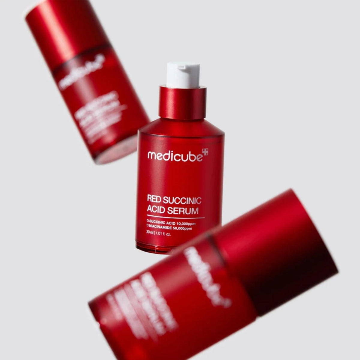 Refect Beauty Medicube Red Succinic Acid Serum bottles for blemish-prone skin in a studio setting.