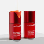 Refect Beauty Medicube Red Succinic Acid Serum bottles with orange serum dripping from the cap on a white surface.