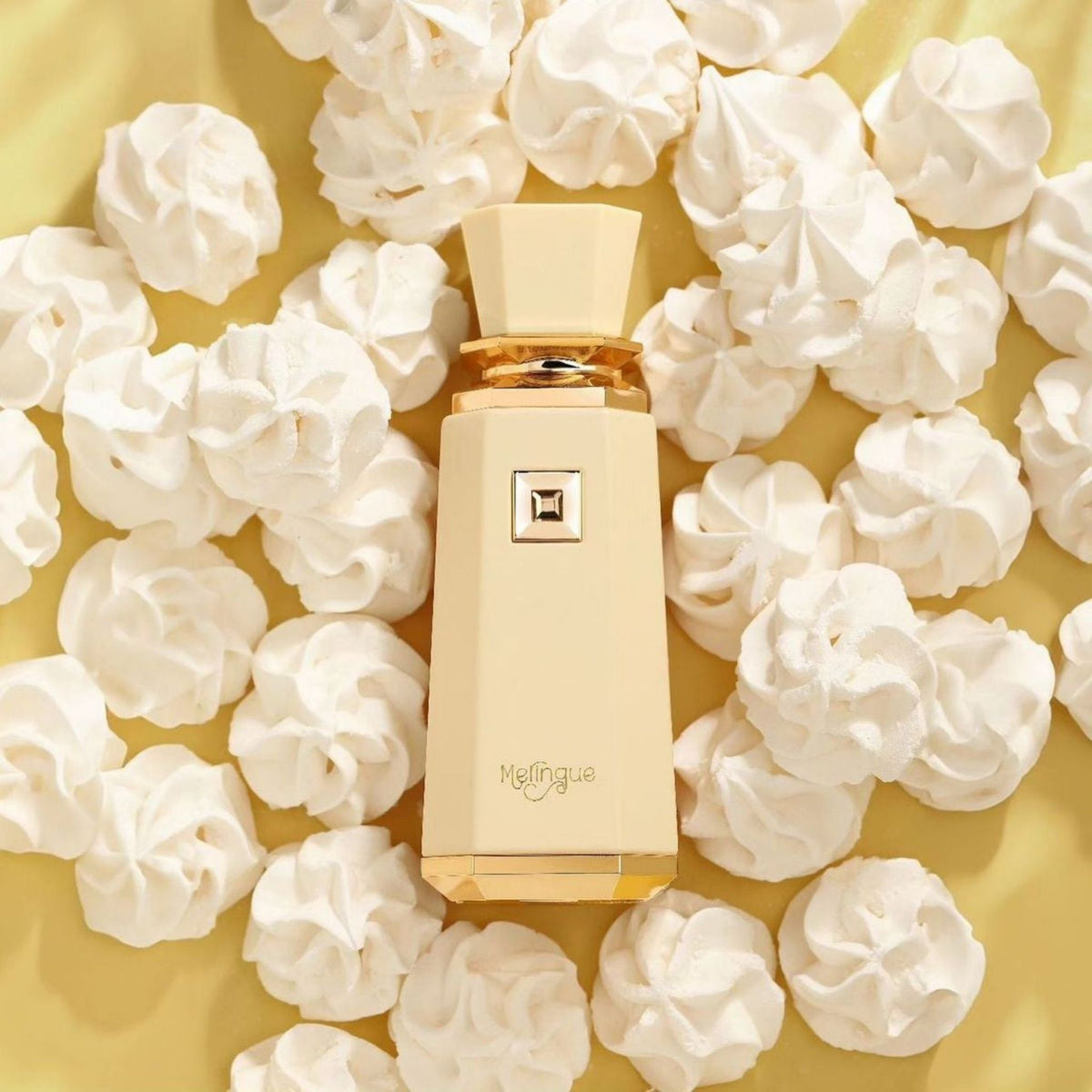 Refect Beauty French Avenue Meringue eau de parfum bottle surrounded by white meringue cookies on a yellow background