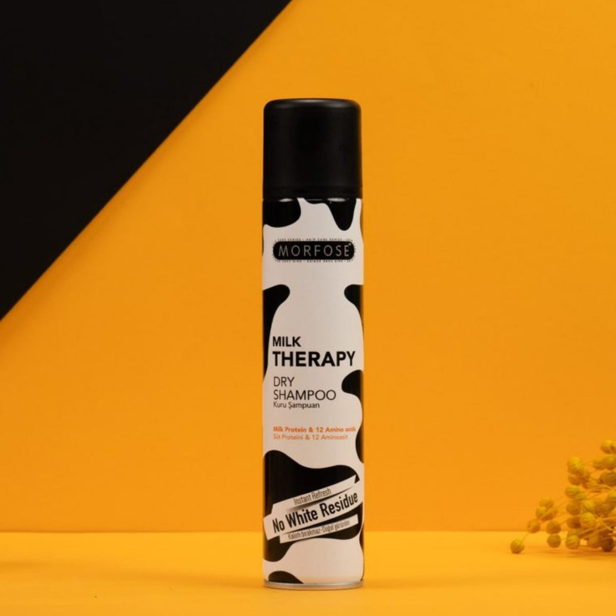 Refect Beauty MORFOSE Milk Therapy dry shampoo spray bottle with a black and white cow print design on yellow background
