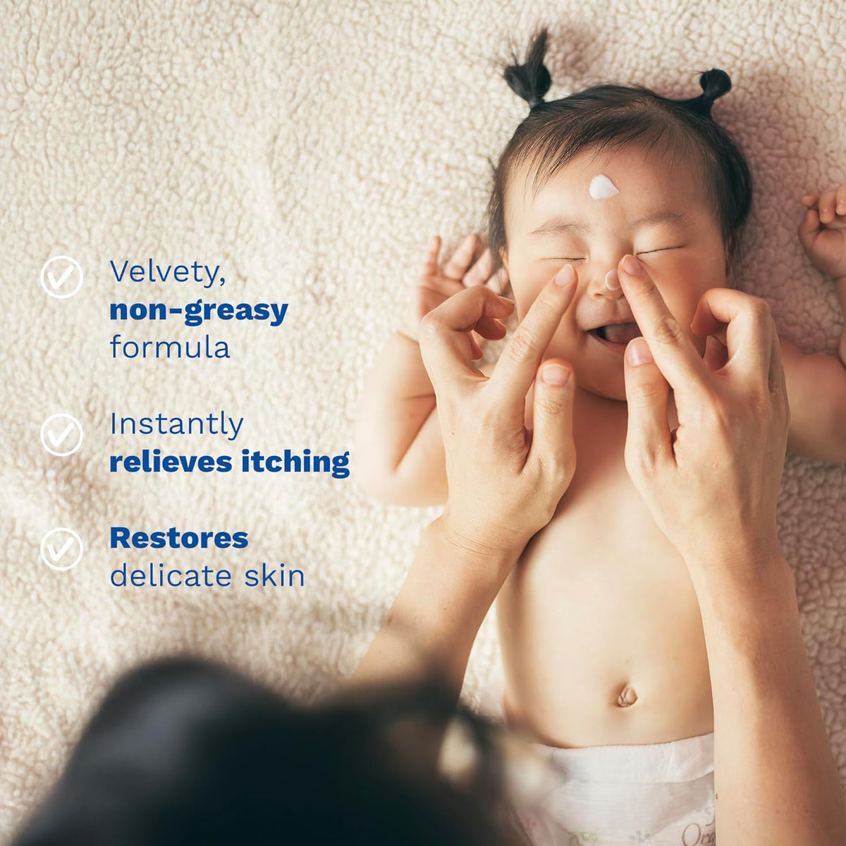 Refect Beauty Mustela Stelatopia emollient cream being applied to a baby's face to soothe dry and eczema-prone skin