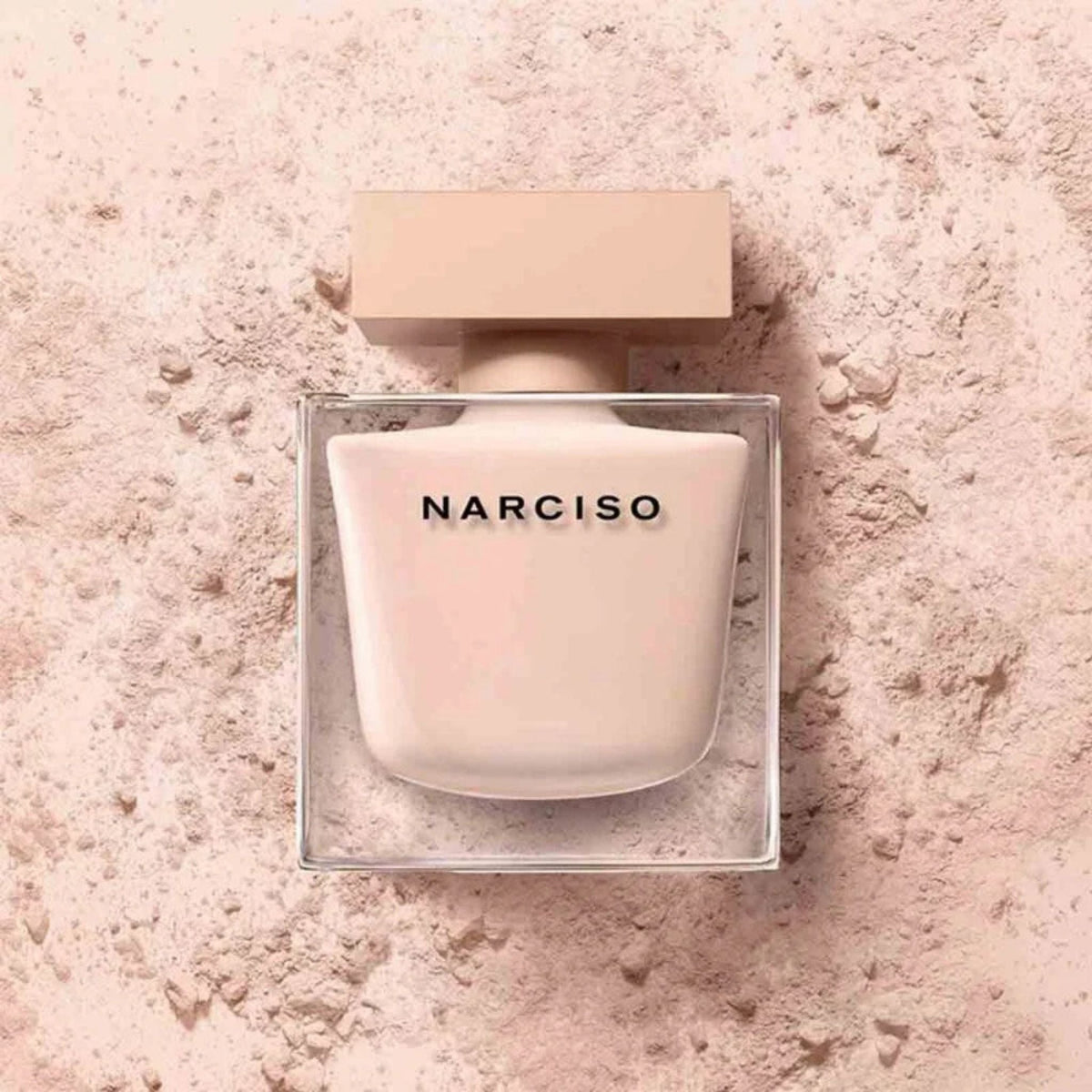 Refect Beauty Narciso Poudree Eau de Parfum in a soft beige glass bottle set against a matching powdery background.