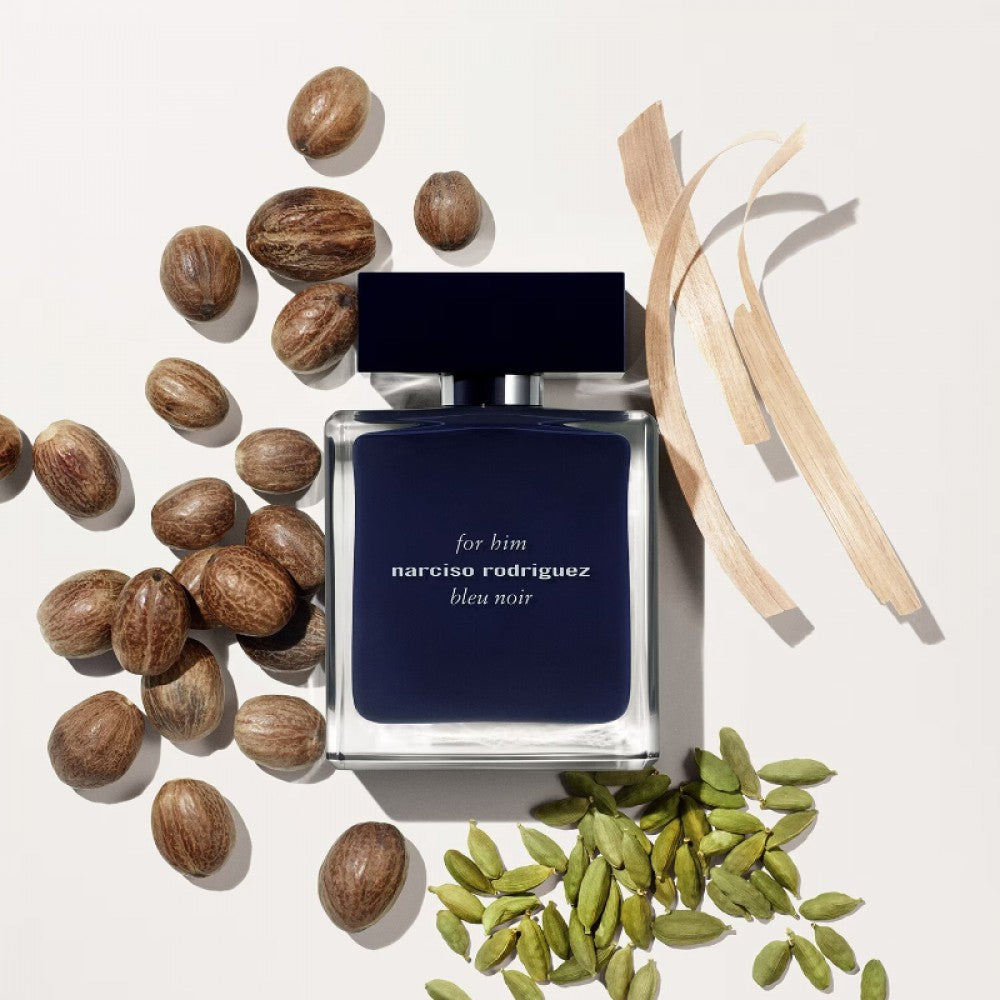 Refect Beauty Narciso Rodriguez Bleu Noir Eau de Parfum bottle surrounded by nutmeg, cardamom, and wood shavings