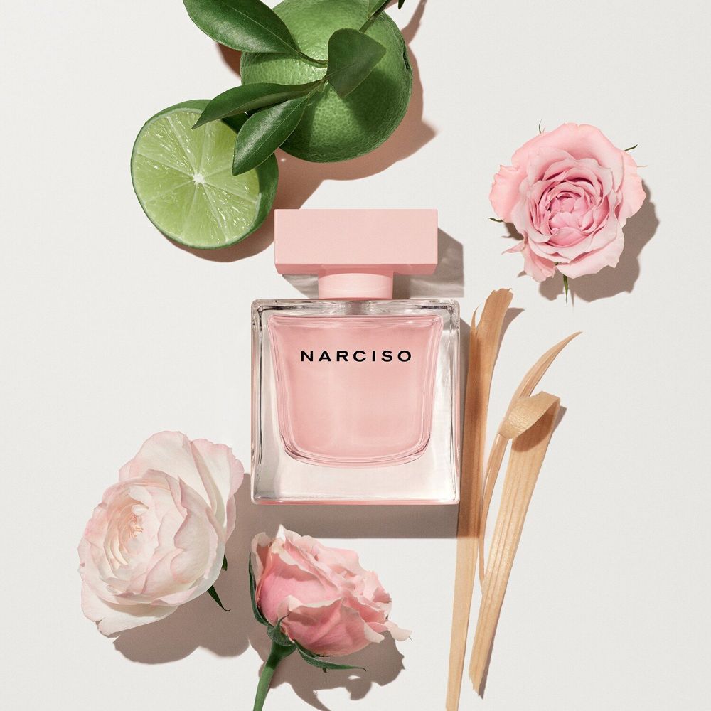 Refect Beauty Narciso Rodriguez Cristal Eau de Parfum bottle surrounded by fresh lime slices and pink roses
