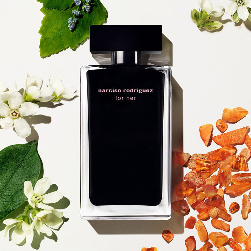Refect Beauty Narciso Rodriguez For Her Eau de Toilette bottle surrounded by white flowers and amber stones