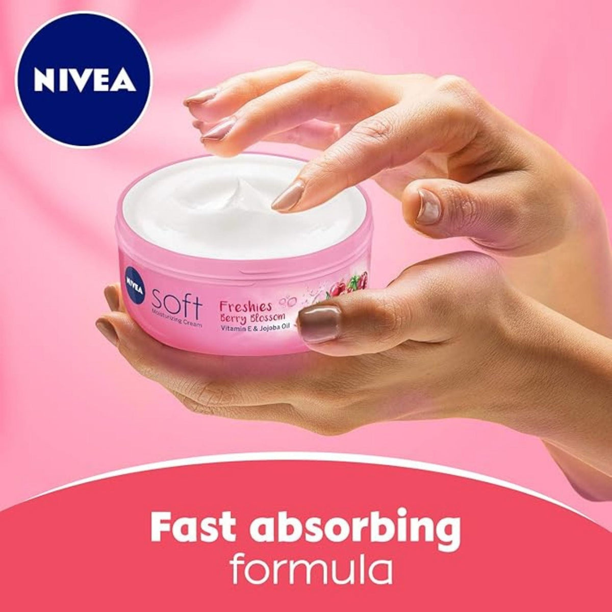 Refect Beauty Nivea Soft Freshies Berry Blossom moisturizing cream in a pink jar held by hands against a pink background
