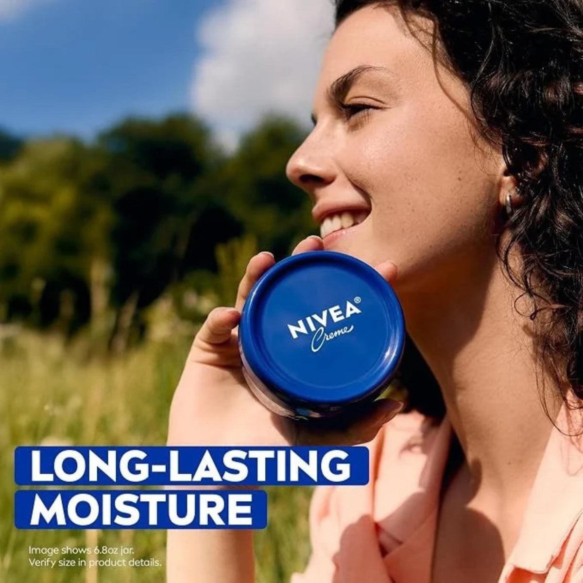 Refect Beauty woman smiling outdoors holding a blue Nivea Creme moisturizing jar for face and body skin care