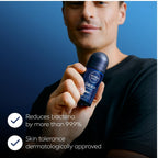 Refect Beauty Nivea Men Deep Black Carbon Dark Wood roll-on deodorant held by a man against a blue background.