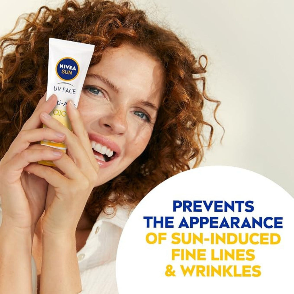 Refect Beauty Nivea Sun Anti-Age Q10 SPF 50 cream held by a smiling woman with curly hair to prevent fine lines