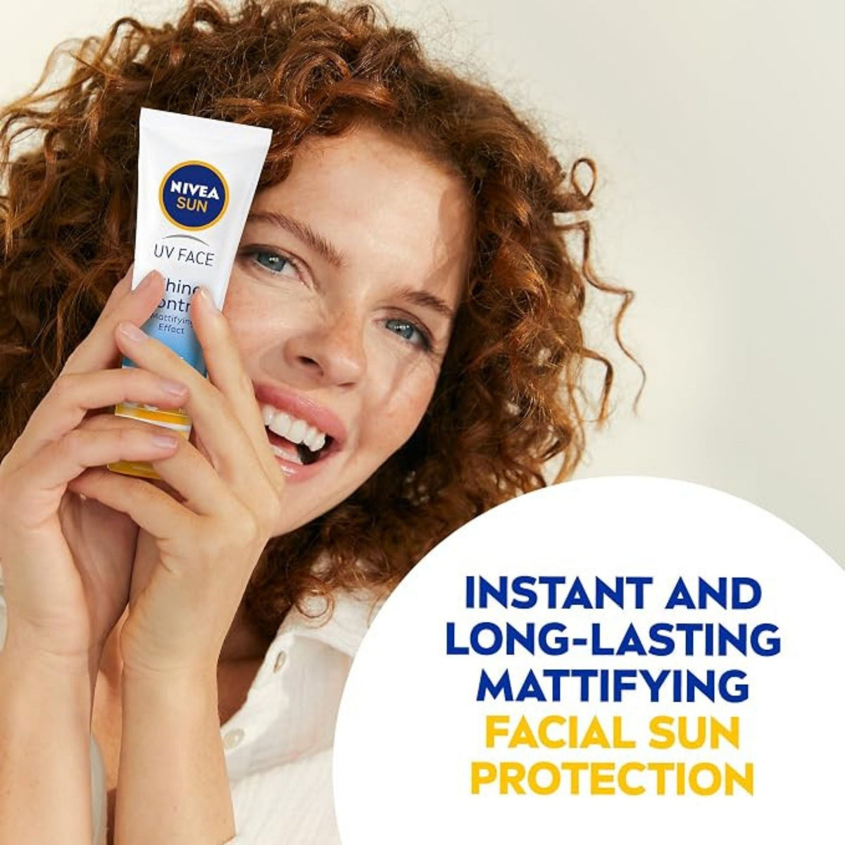 Refect Beauty model smiling while holding Nivea Sun Face Cream SPF 50 for matte facial sun protection
