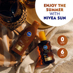 Refect Beauty Nivea Sun Intense Bronze tanning oil spray bottles with SPF 6 on a beach towel and straw hat background