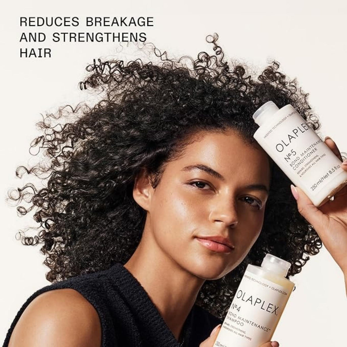 Refect Beauty model holding Olaplex No.4 shampoo and No.5 conditioner bottles to promote hair repair and strength