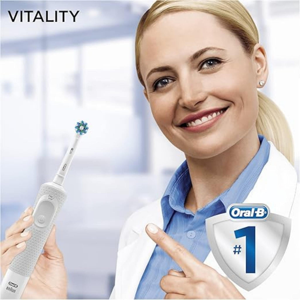 Refect Beauty Oral-B Vitality 100 electric toothbrush held by a smiling dentist in a clinical office setting