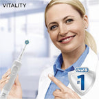 Refect Beauty Oral-B Vitality 100 electric toothbrush held by a smiling dentist in a clinical office setting