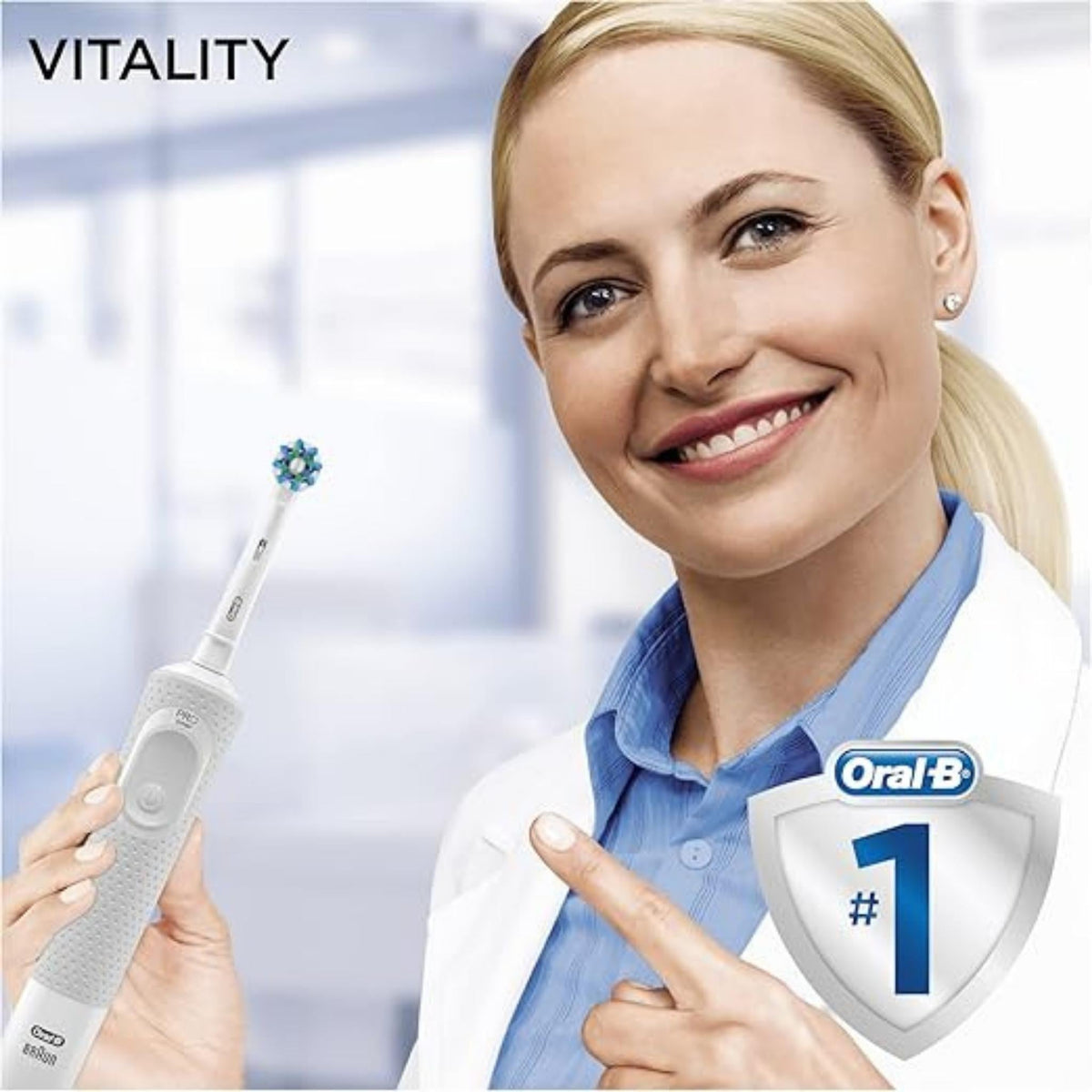 Refect Beauty Oral-B Vitality 100 electric toothbrush held by a smiling dentist in a clinical office setting