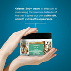 Refect Beauty Oriense Coconut Milk Body Cream jar held in hands against a blue background for deep skin hydration.