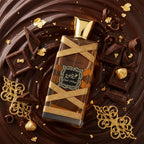 Refect Beauty Lattafa Oud Mood Elixir perfume bottle surrounded by dark chocolate pieces and gold leaf accents