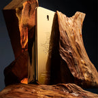 Refect Beauty Paco Rabanne 1 Million gold bar shaped fragrance bottle nestled between rustic wooden logs