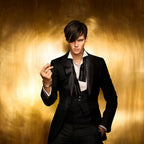 Refect Beauty model in a black tuxedo against a gold background promoting Paco Rabanne 1 Million Night Elixir perfume