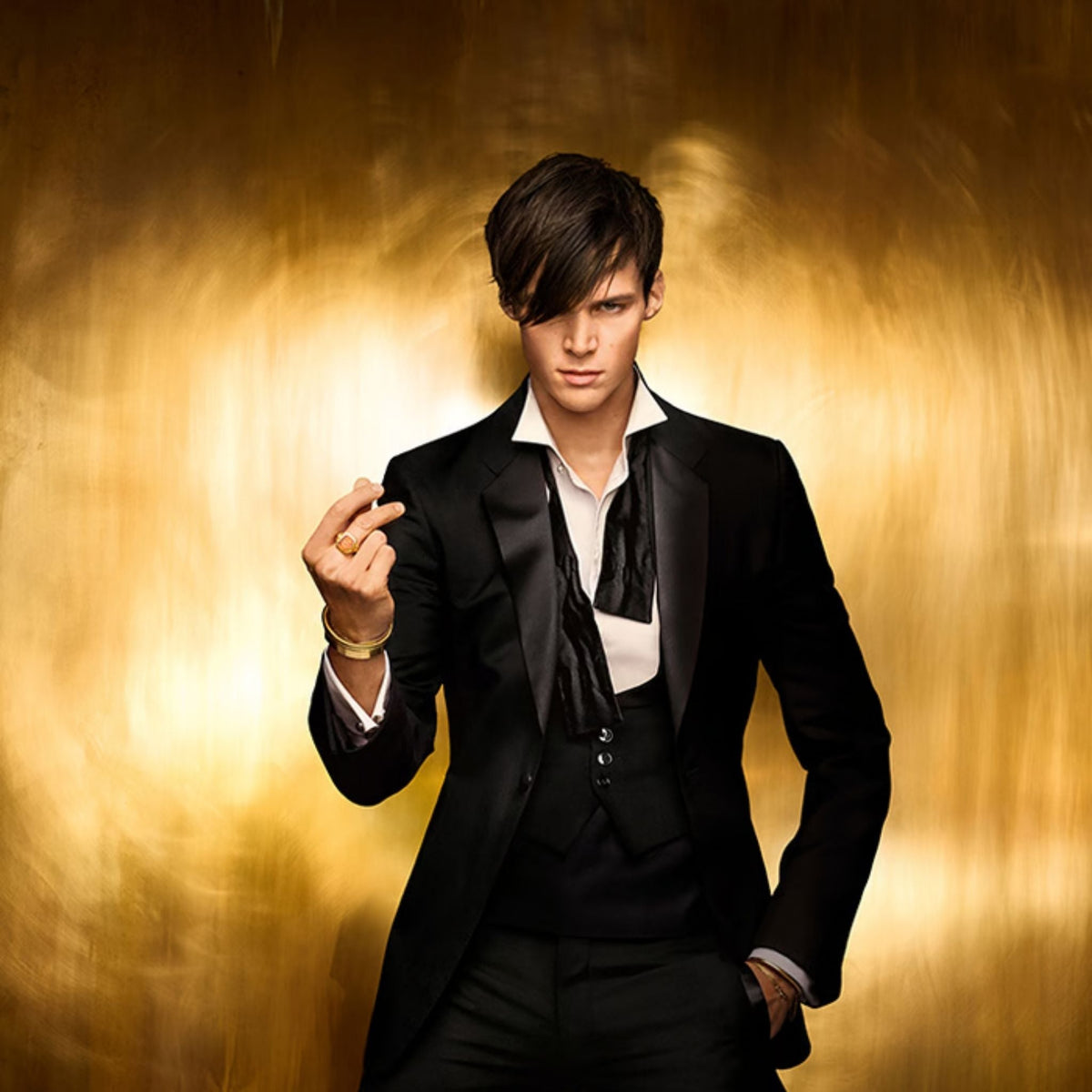 Refect Beauty model in a black tuxedo against a gold background promoting Paco Rabanne 1 Million Night Elixir perfume