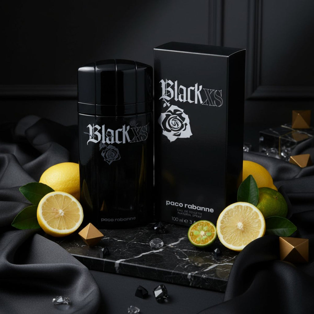 Refect Beauty Paco Rabanne Black XS eau de toilette bottle and box with fresh lemons on a black marble surface.