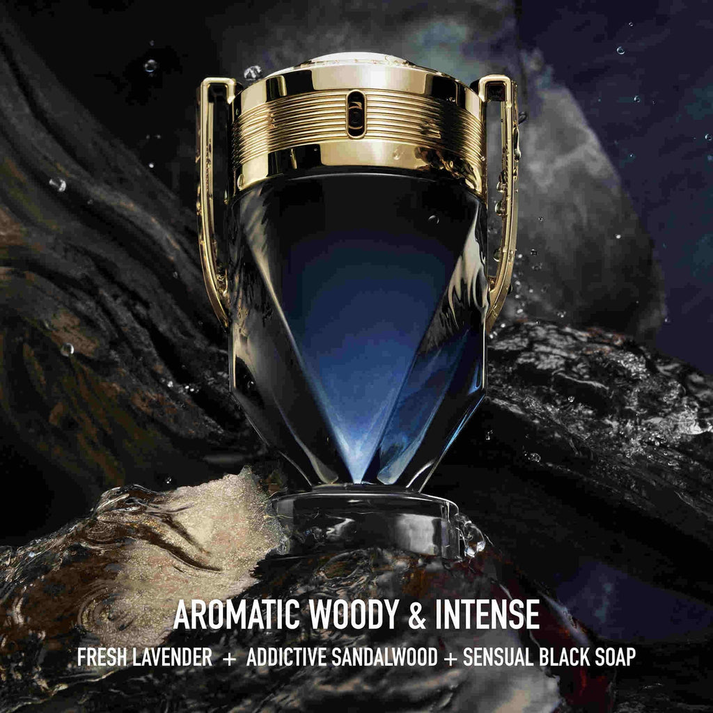 Refect Beauty Paco Rabanne Invictus Parfum bottle with gold trophy design on a dark, rocky, aquatic background.