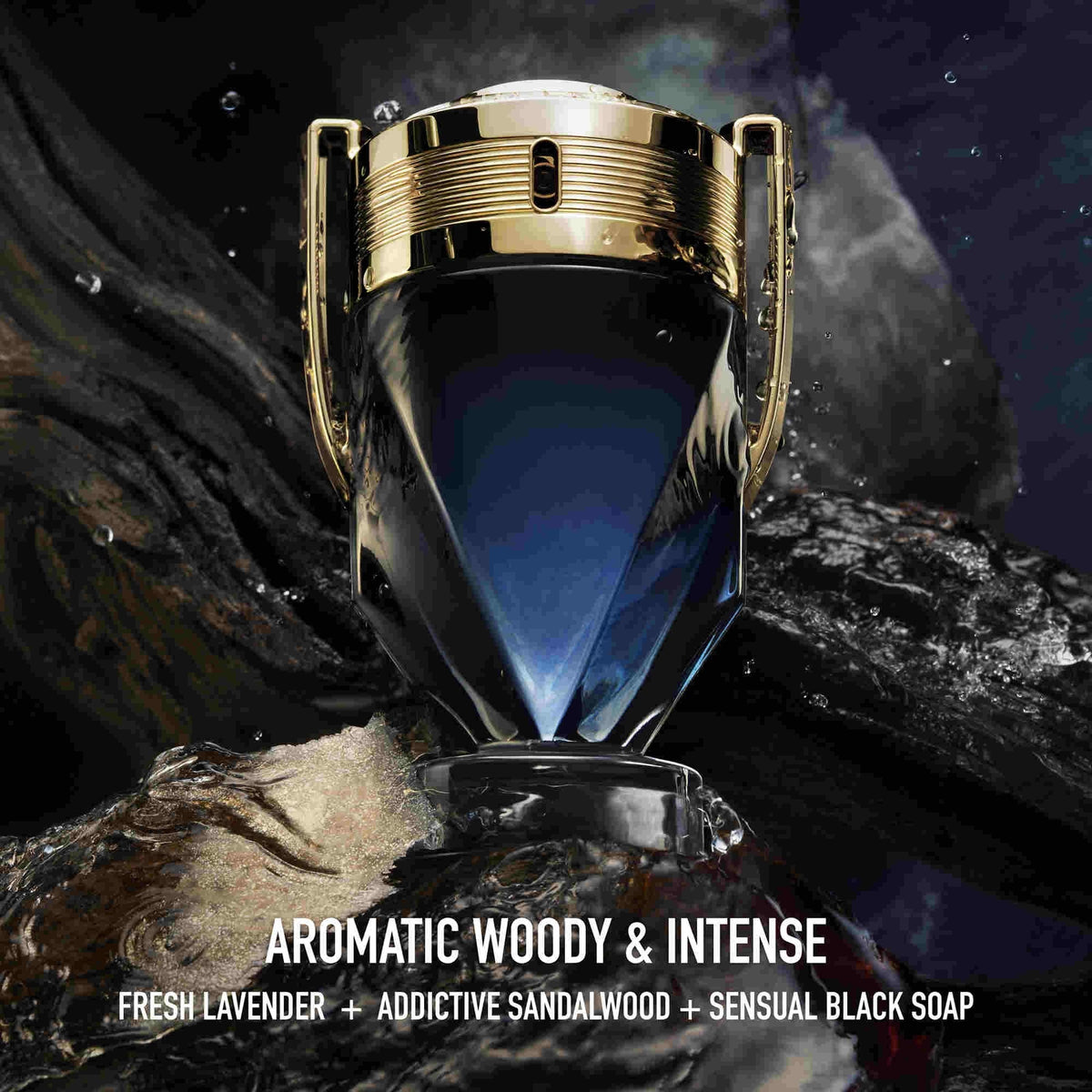 Refect Beauty Paco Rabanne Invictus Parfum bottle with gold trophy design on a dark, rocky, aquatic background.