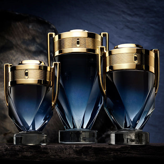 Refect Beauty Paco Rabanne Invictus Parfum bottles in three sizes with blue gradient glass and gold trophy-style caps